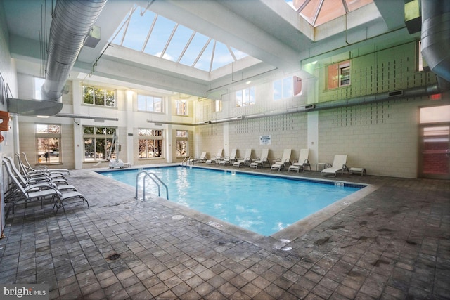 view of swimming pool featuring a skylight