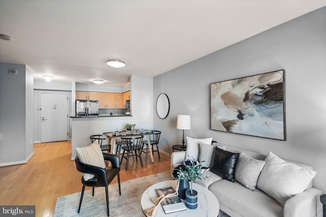 living room with light hardwood / wood-style flooring