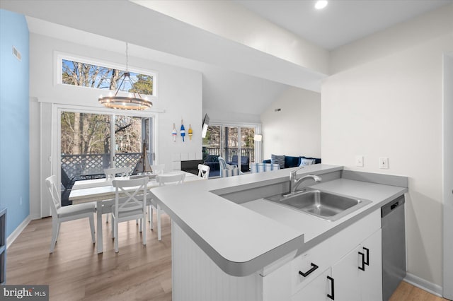 kitchen with pendant lighting, dishwasher, white cabinets, sink, and kitchen peninsula