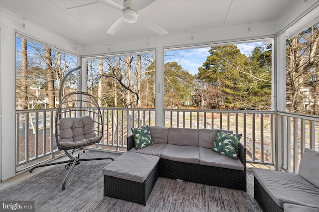 sunroom / solarium featuring ceiling fan