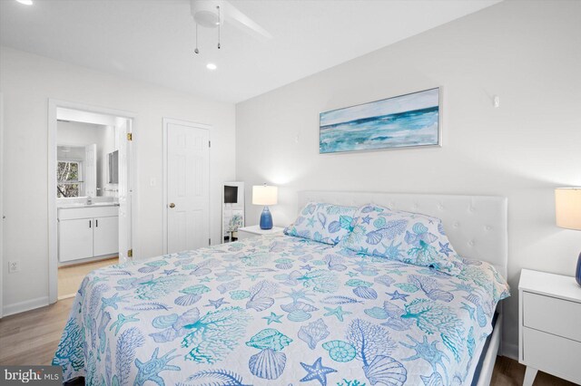 bedroom featuring ensuite bathroom, ceiling fan, and light hardwood / wood-style floors