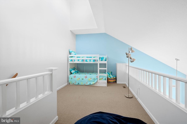 carpeted bedroom featuring lofted ceiling