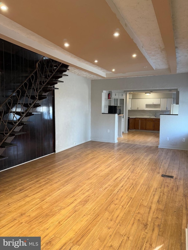 unfurnished living room featuring light hardwood / wood-style floors