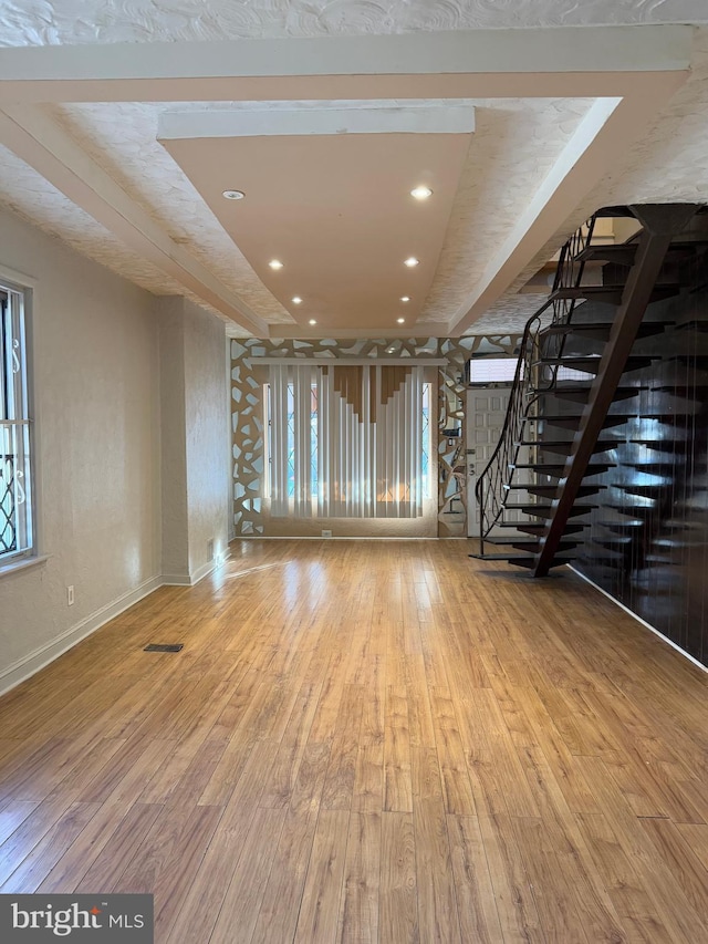 unfurnished living room with wood-type flooring