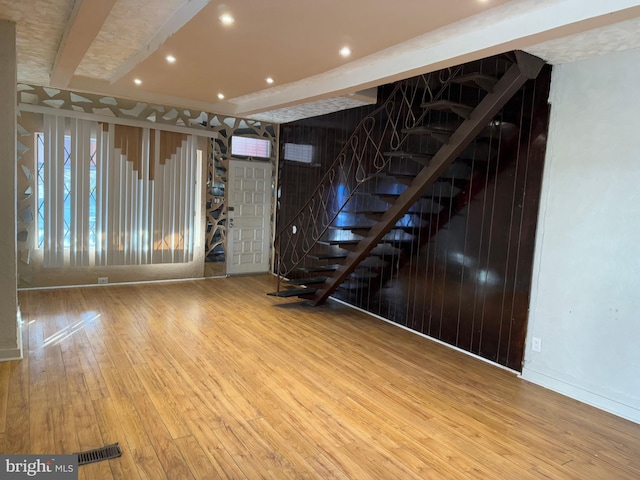 basement featuring wood-type flooring and a wealth of natural light