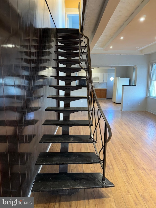 stairs featuring hardwood / wood-style floors