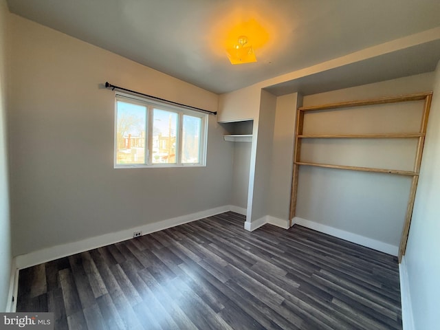 unfurnished bedroom featuring dark hardwood / wood-style floors and a closet