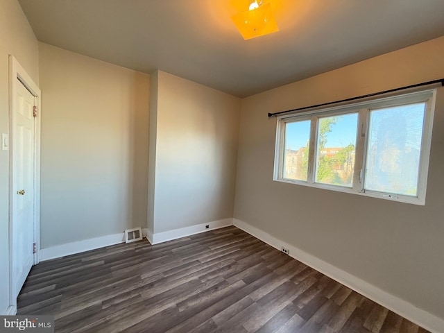 unfurnished room featuring dark hardwood / wood-style flooring