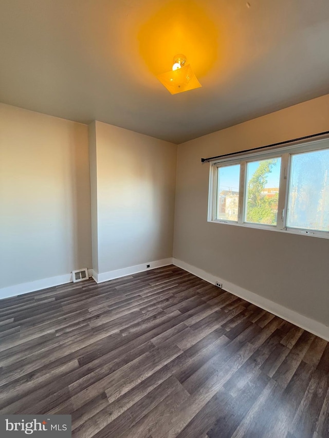 spare room featuring dark hardwood / wood-style floors