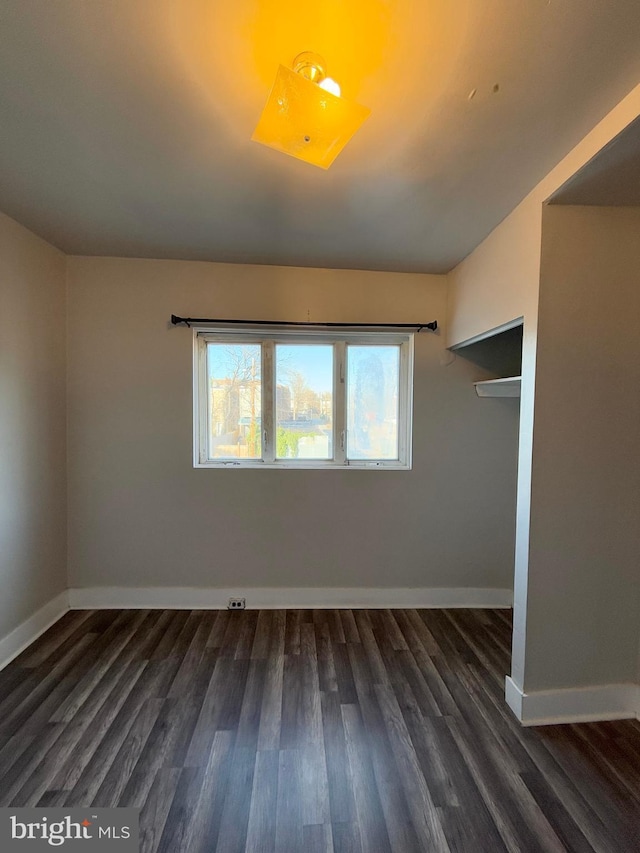 empty room featuring dark wood-type flooring