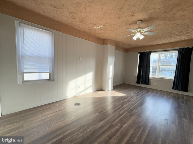 empty room featuring ceiling fan and dark wood-type flooring