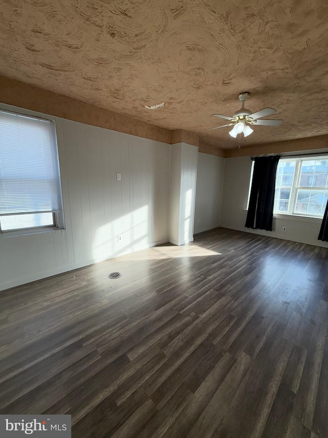 spare room with dark hardwood / wood-style floors and ceiling fan