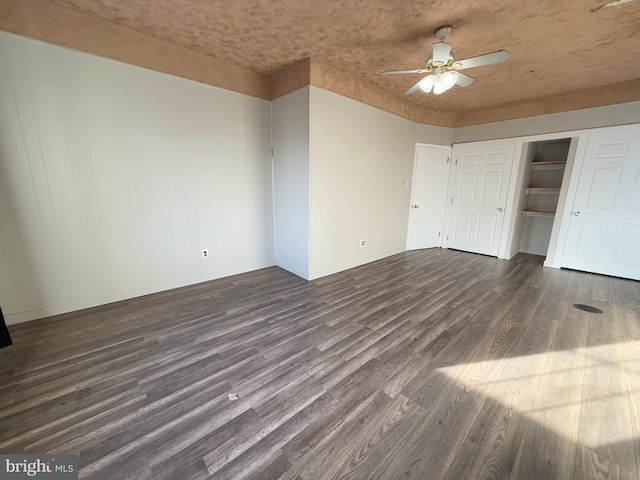 interior space with ceiling fan and dark hardwood / wood-style flooring