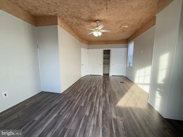 empty room featuring dark hardwood / wood-style floors and ceiling fan