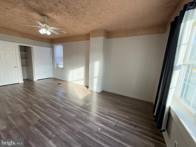 spare room with ceiling fan and dark wood-type flooring