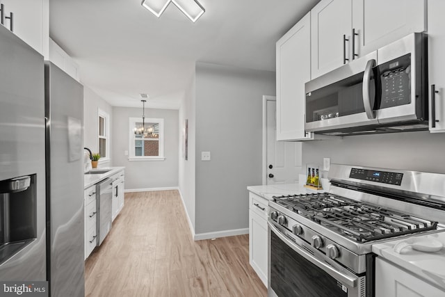 kitchen featuring light stone countertops, white cabinets, and appliances with stainless steel finishes