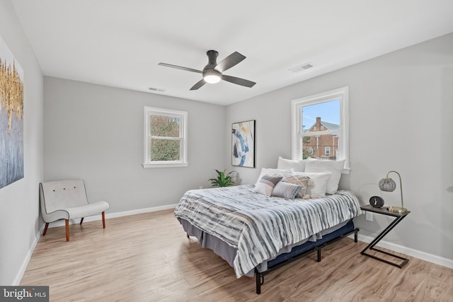 bedroom with light hardwood / wood-style flooring and ceiling fan