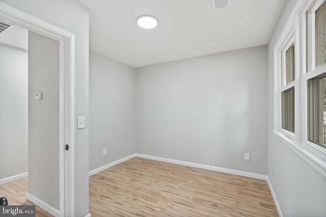 unfurnished room with light wood-type flooring