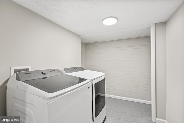 laundry area featuring a textured ceiling and washer and clothes dryer