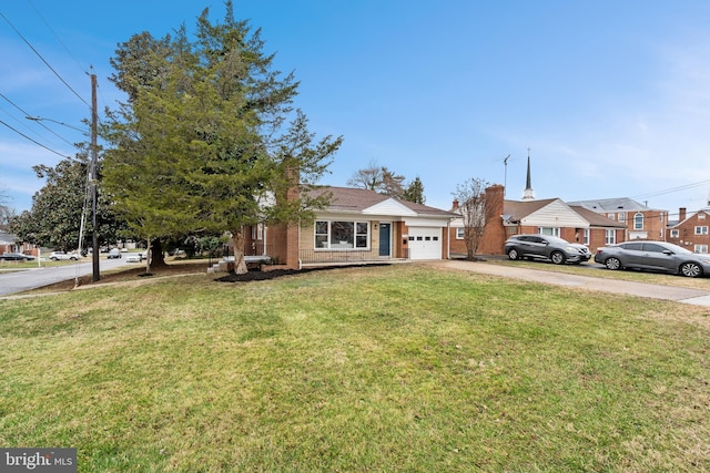 view of front of home with a garage and a front lawn