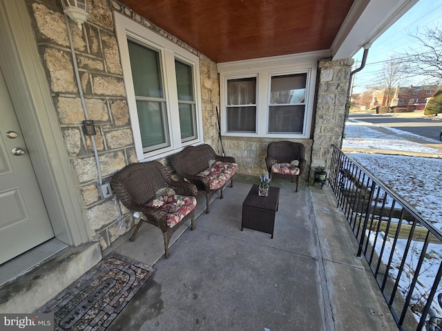 snow covered patio featuring outdoor lounge area