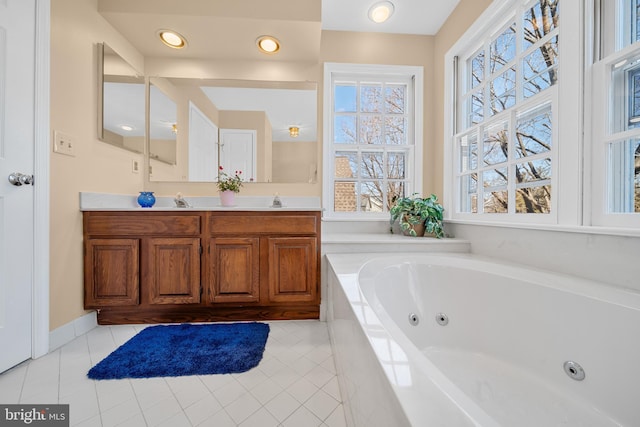 full bath with a jetted tub, tile patterned flooring, double vanity, and a sink