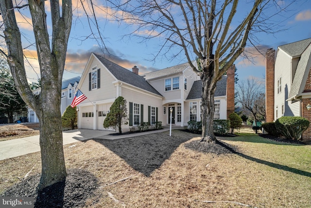 view of front of home with concrete driveway and an attached garage