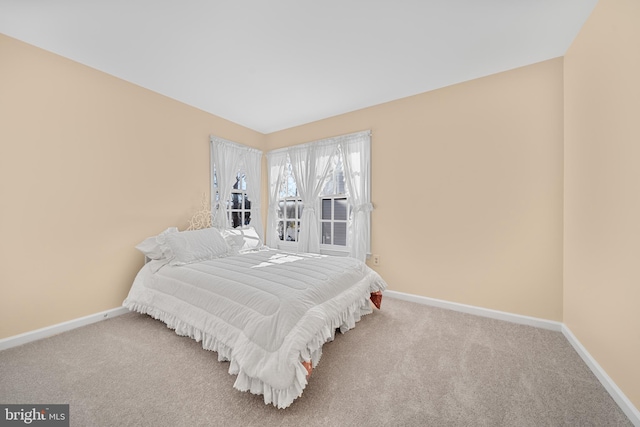 carpeted bedroom featuring baseboards