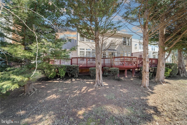 rear view of house with a wooden deck