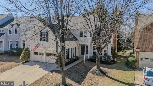 view of front of home featuring concrete driveway and an attached garage