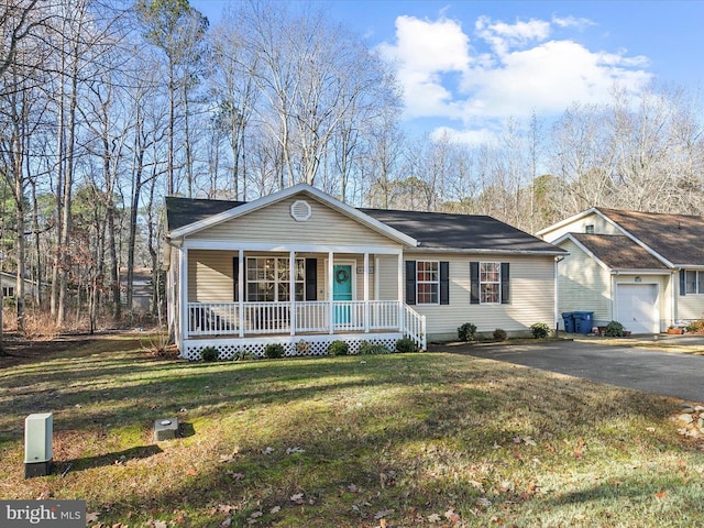 single story home featuring a porch, a garage, and a front lawn