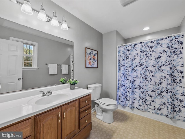 bathroom with curtained shower, vanity, and toilet