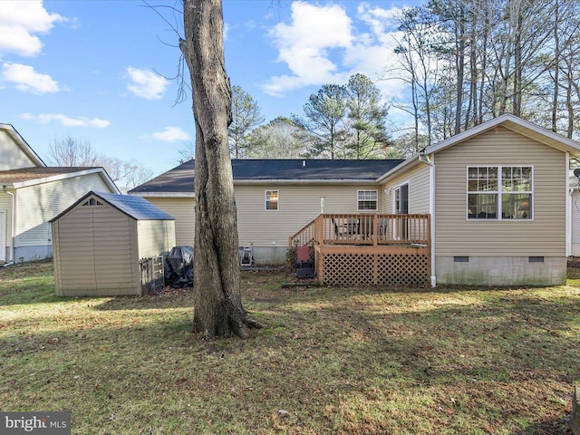 back of house with a wooden deck, a yard, and a storage unit