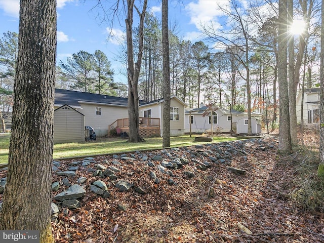 exterior space featuring a wooden deck and a yard