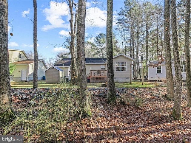 rear view of property with a wooden deck