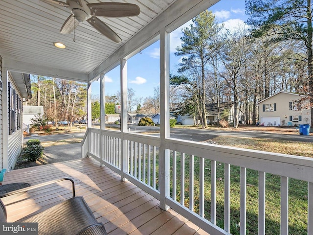 wooden terrace with ceiling fan and covered porch