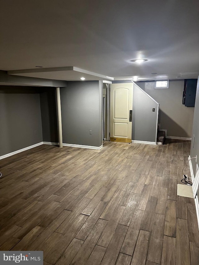 basement with hardwood / wood-style flooring