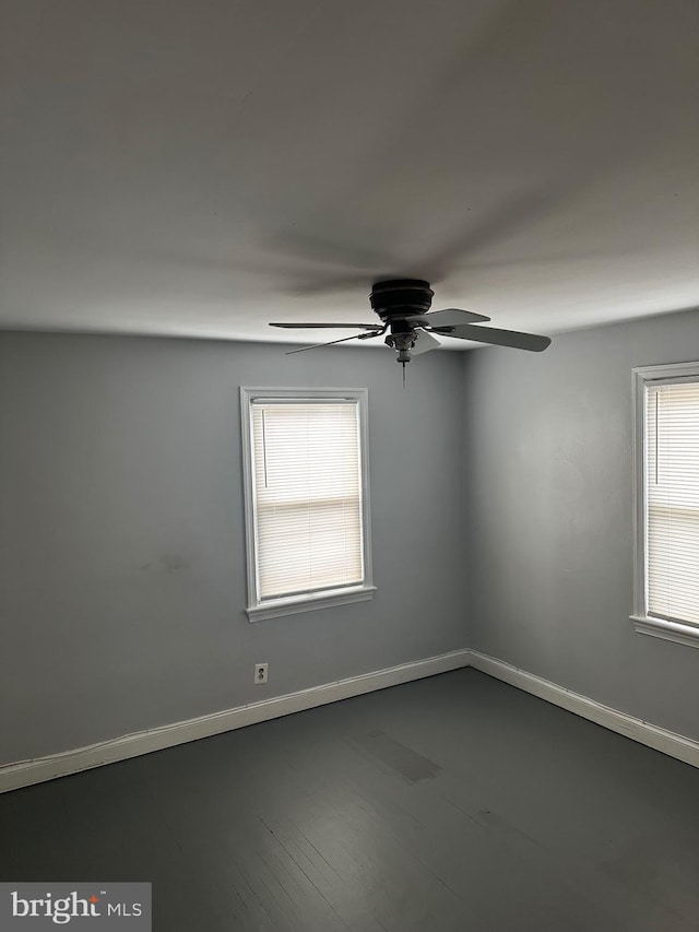 unfurnished room featuring a wealth of natural light, ceiling fan, and wood-type flooring