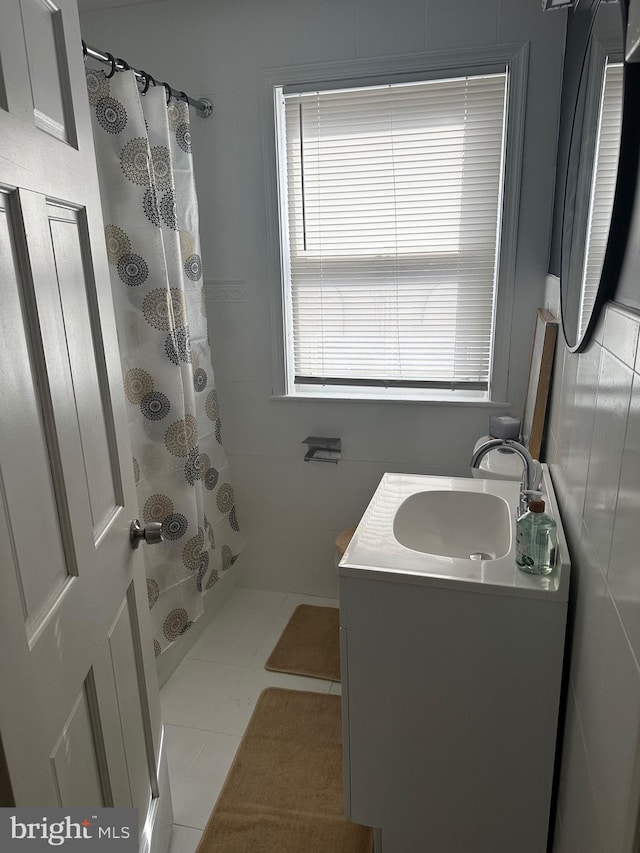 bathroom featuring tile patterned flooring, vanity, and a shower with shower curtain