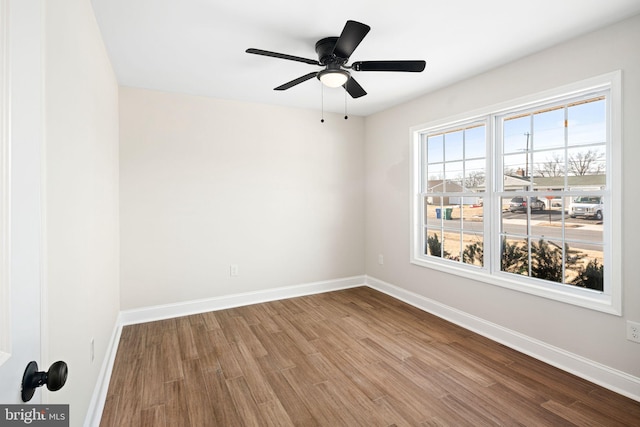 spare room featuring ceiling fan and hardwood / wood-style flooring