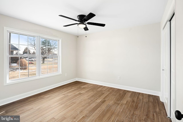 unfurnished bedroom with a closet, light hardwood / wood-style flooring, and ceiling fan