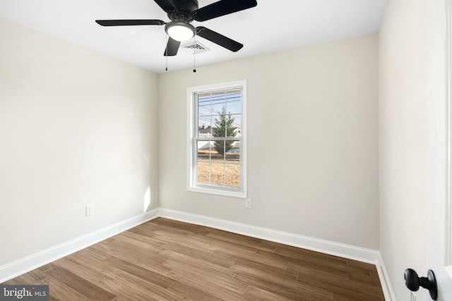 empty room with ceiling fan and hardwood / wood-style flooring