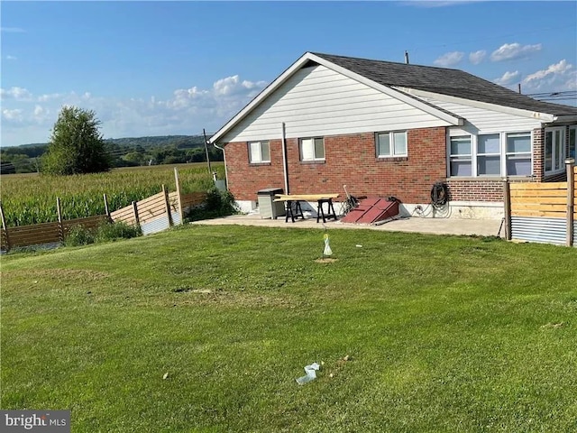 back of house featuring a yard and a patio