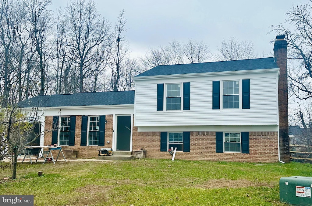 split level home featuring a front lawn