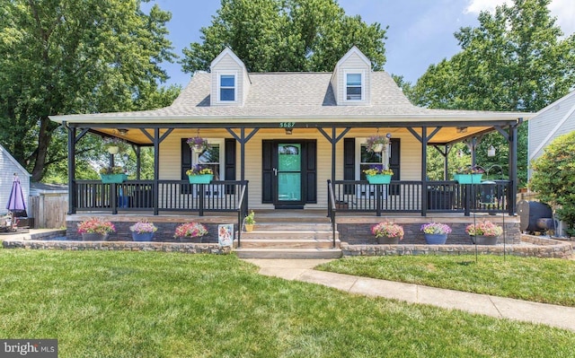 view of front of home with a front yard and a porch