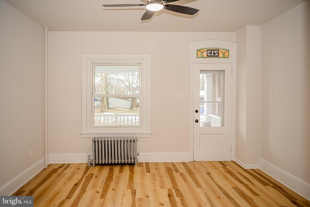 entryway with radiator heating unit, ceiling fan, and hardwood / wood-style floors