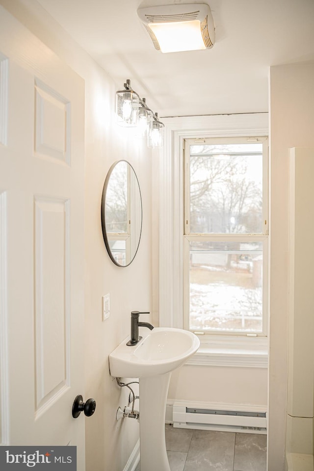 bathroom with tile patterned flooring and baseboard heating