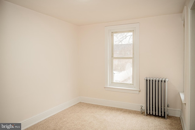 carpeted empty room with radiator