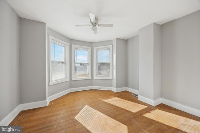 spare room featuring hardwood / wood-style floors and ceiling fan