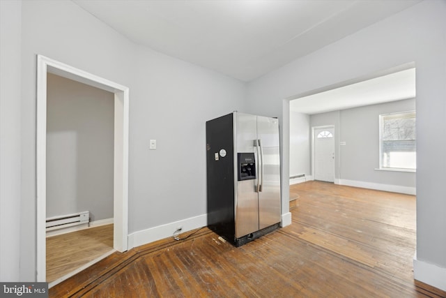 kitchen featuring baseboard heating, wood-type flooring, and stainless steel refrigerator with ice dispenser